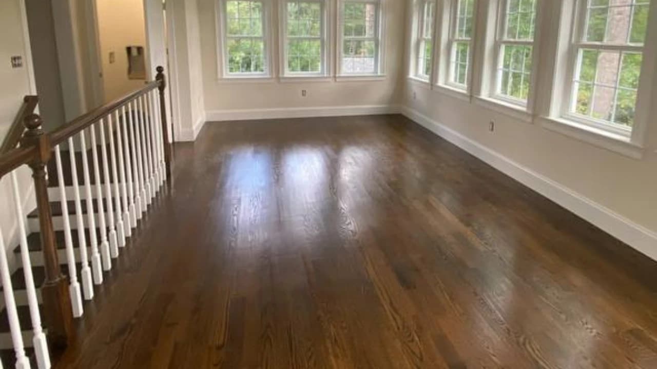Refinished red oak hardwood with rich dark stain in a Massachusetts bay-window living room, Kovich & Savard